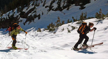 A group of skiers skin uphill in the Washington Pass backcountry.